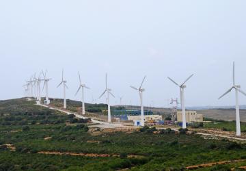 A wind turbine farm on a cloudy day. 