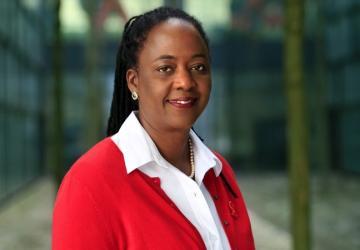 A woman in a red suit and white shirt