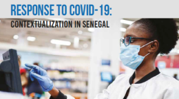 Cover shows the title above a photo of a woman wearing a face mask and gloves ringing up a purchase at a cash register in a store.