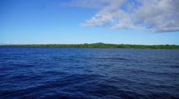 An illustrative of an ocean, with deep blue water, and a light blue sky above.