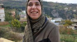 Woman in a headscarf smiling at the camera