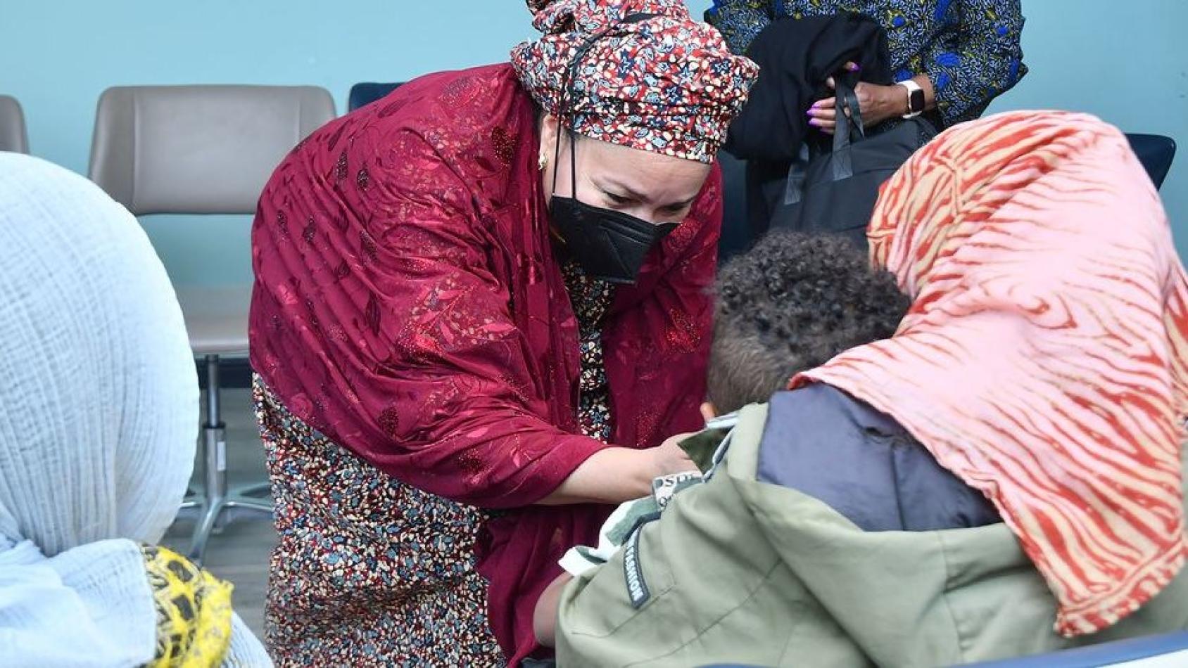 The Deputy Secretary-General Amina Mohammed and a small group of women having an emotional exchange.