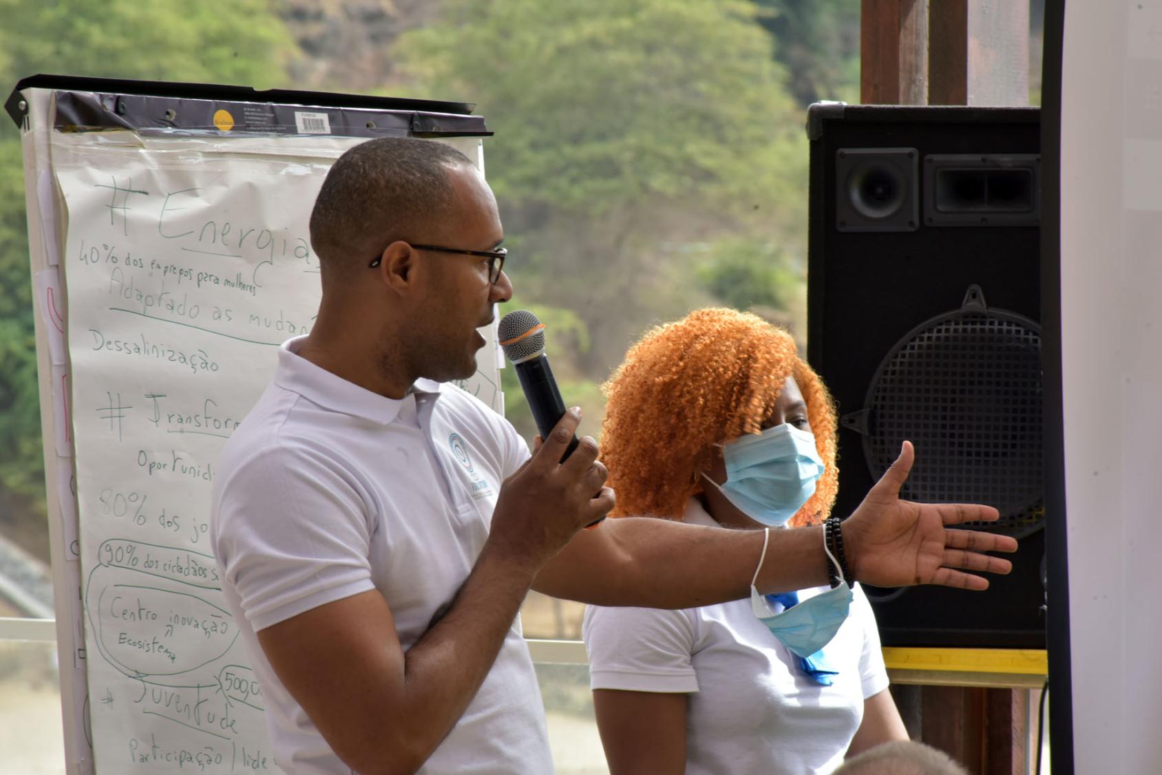 Dos facilitadores de las Naciones Unidas en Cabo Verde utilizan un micrófono para dar una explicación durante el taller.