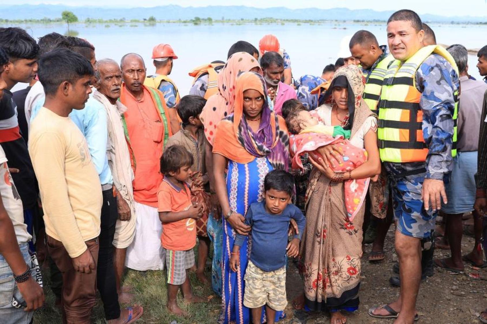 Security personnel rescue people from an inundated settlement of Banke District