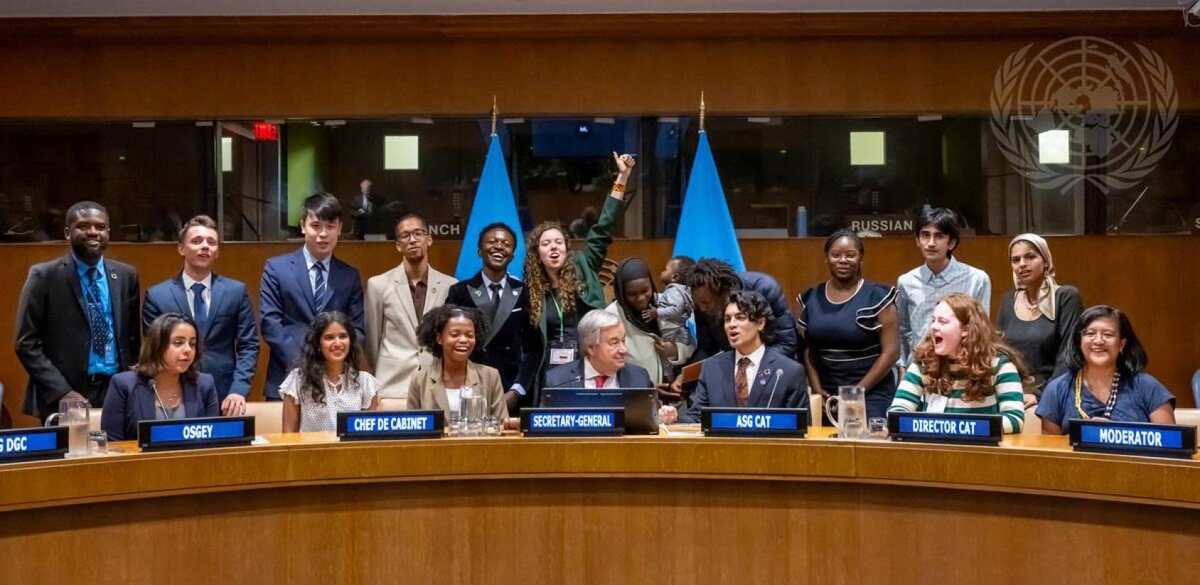 A podium with several people in suits sitting