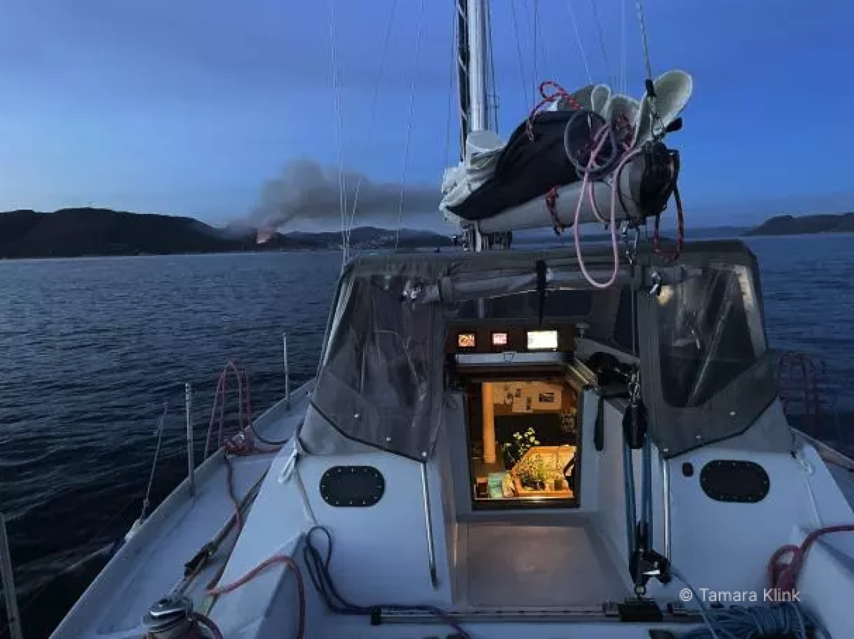 A view of a small boat's deck on a peaceful ocean. 