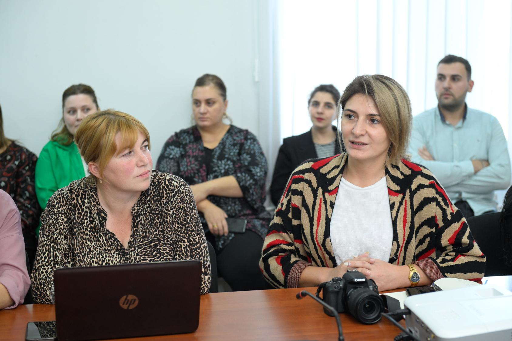Women at a community level meeting indoors