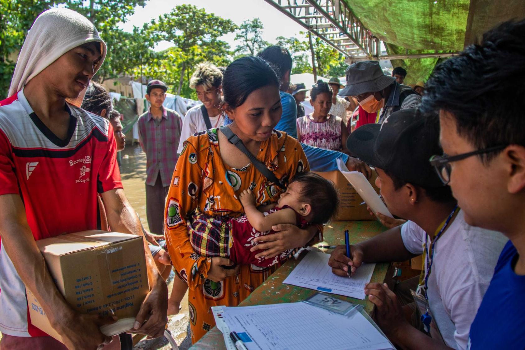 A woman receives humanitarian relief supplies