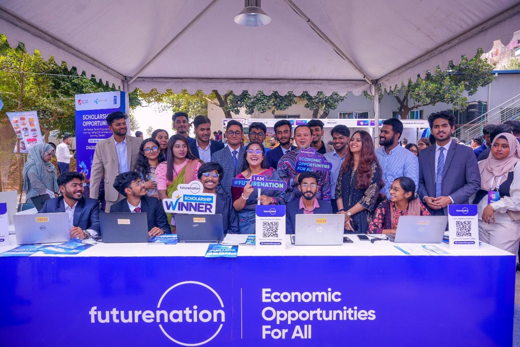A group of young people looking at the camera and smiling