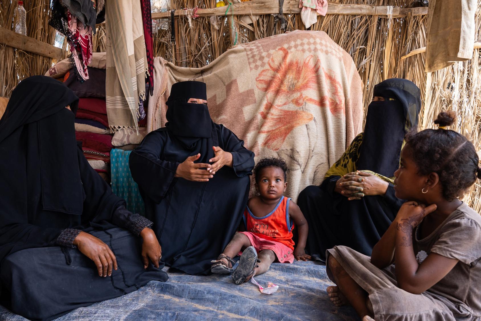 A group of women in full garb talk amongst themselves