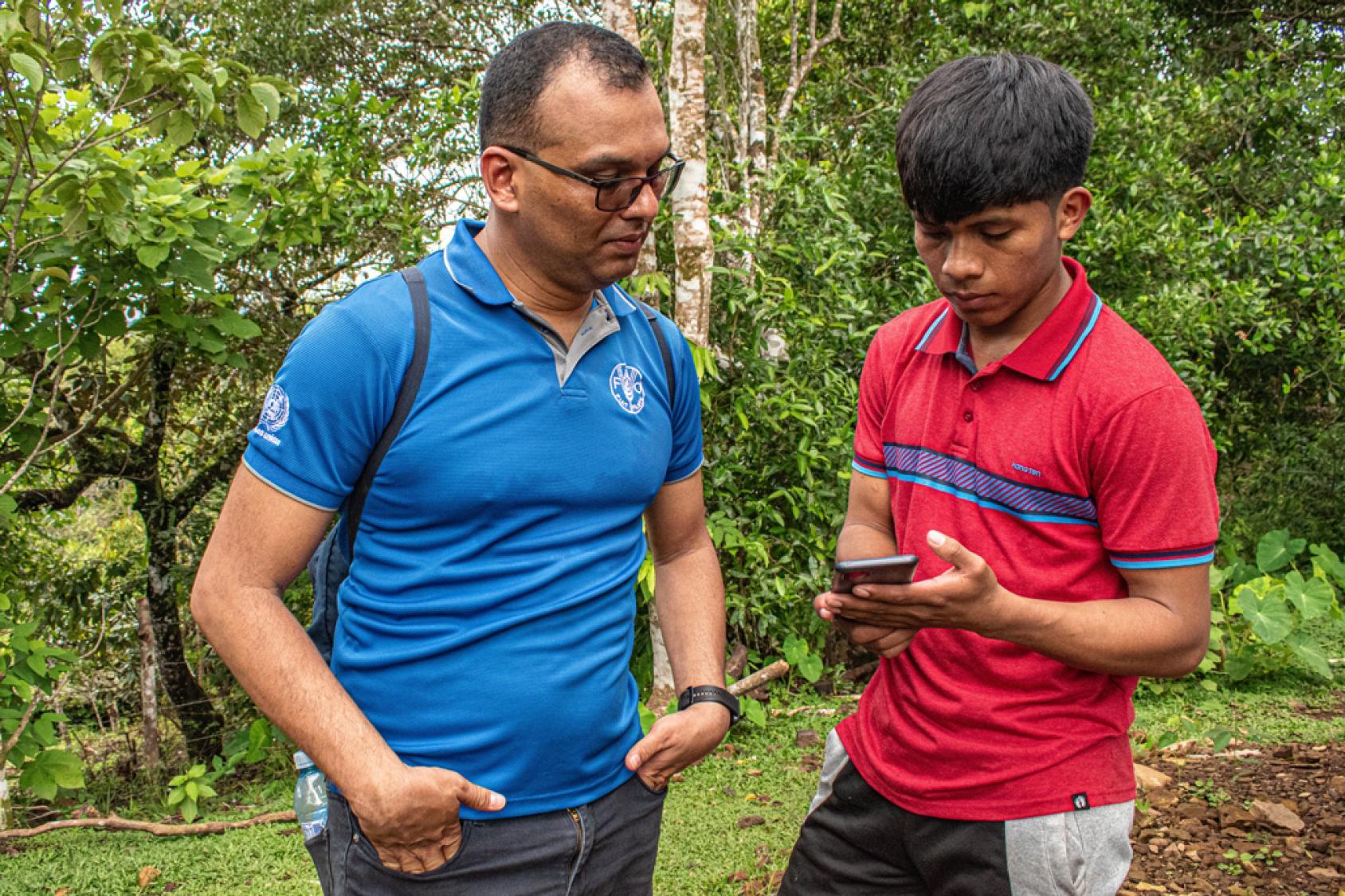 two men looking at a phone