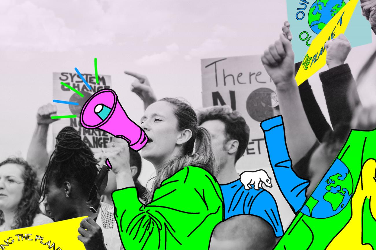 Youth protesters stand with signs while a young girl speaks into a bullhorn.