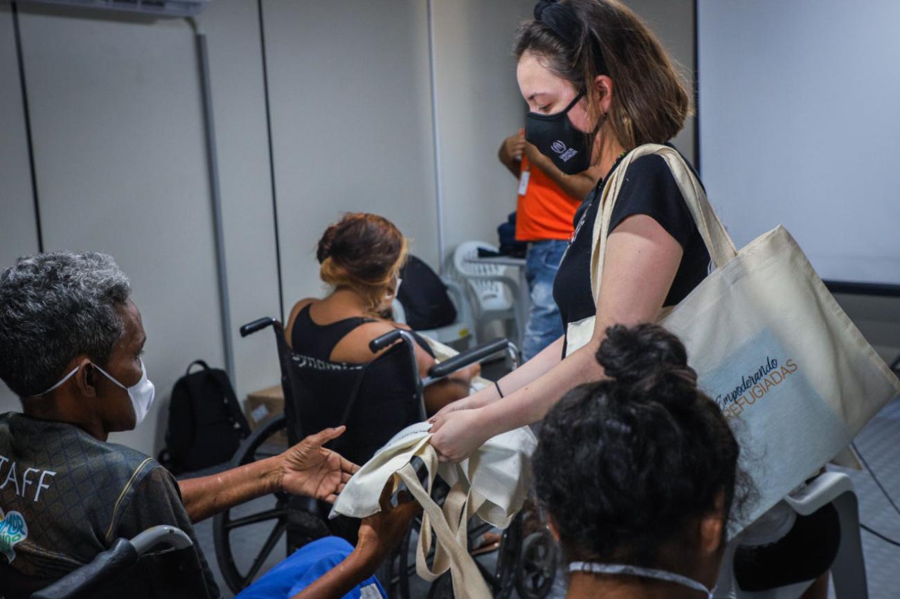 Training course staff provide participants a tote bag. 