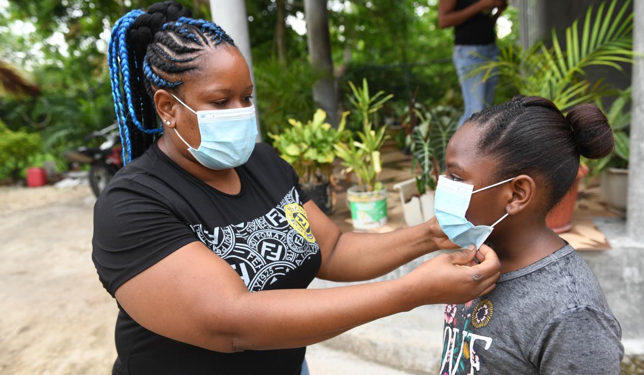 Kaedia Ellis Johson adjust the face mask for her daughter Sasheena Johnson astudent of Little Bay Primary and Infant School. On Monday, September 7,2020. Little Bay is a mainly fishing community located in the parish of Westmoreland, the western end of the island of Jamaica.