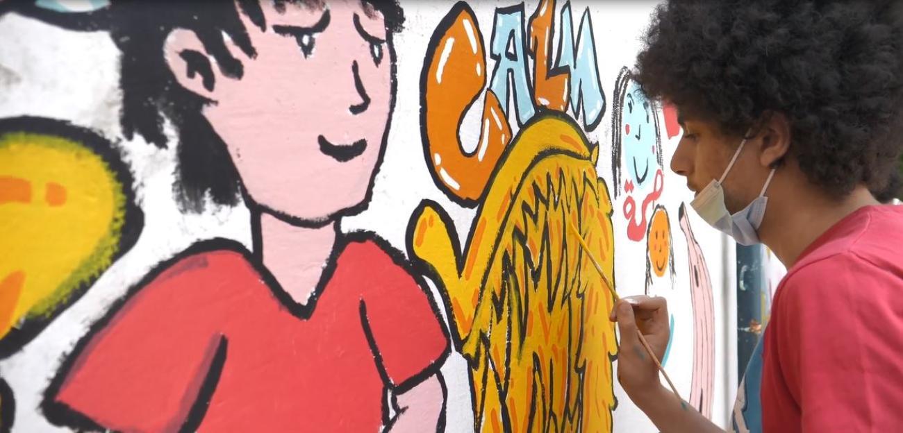 Child painting a mural in the playground of Khaled Bin Waleed School in Beirut, which was damaged by the port blasts and rehabilitated by UNESCO