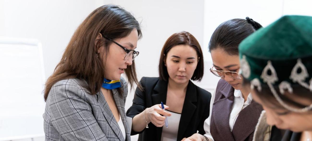 Four women at a training for consultants of Women's Entrepreneurship Development Centers.