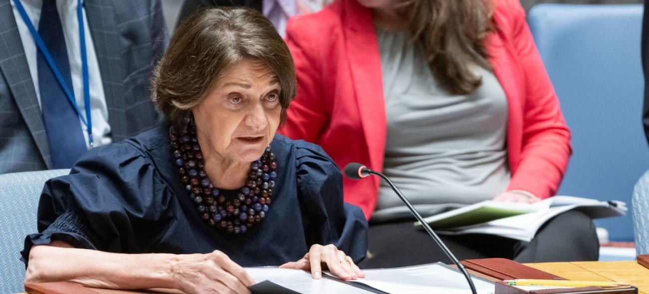 Women in white chef's uniforms sit at a table.
