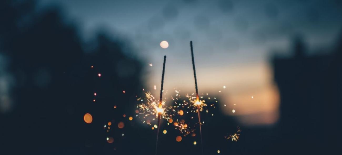 два бенгальских огня горящих на фоне закатного неба