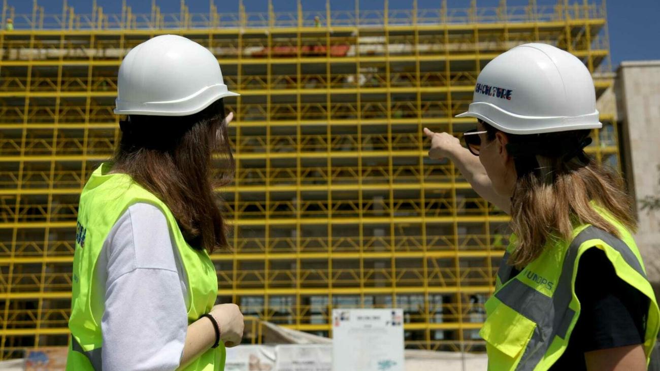 Two women in an outdoor setting looking at an infrastructure project