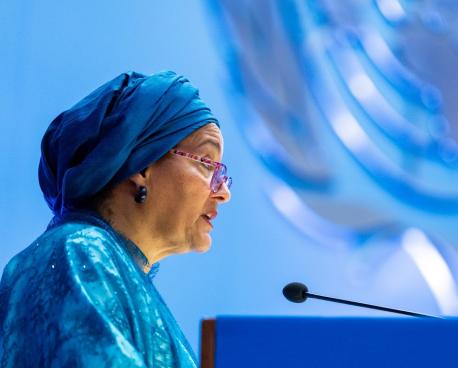 test image - woman in blue speaks at podium