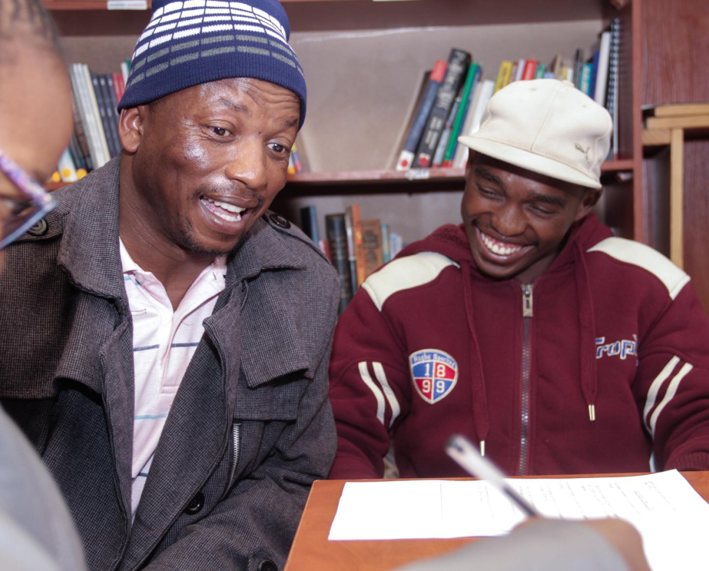 Two men speaking with woman