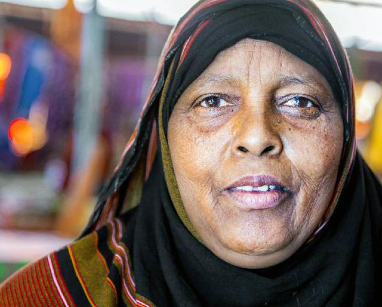 Shows a close-up of Khadra looking directly at the camera.