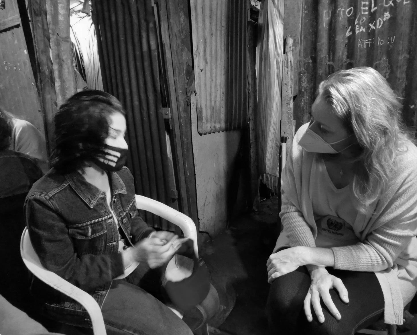 Lilith sits with Resident Coordinator Allegra Baiocchi.