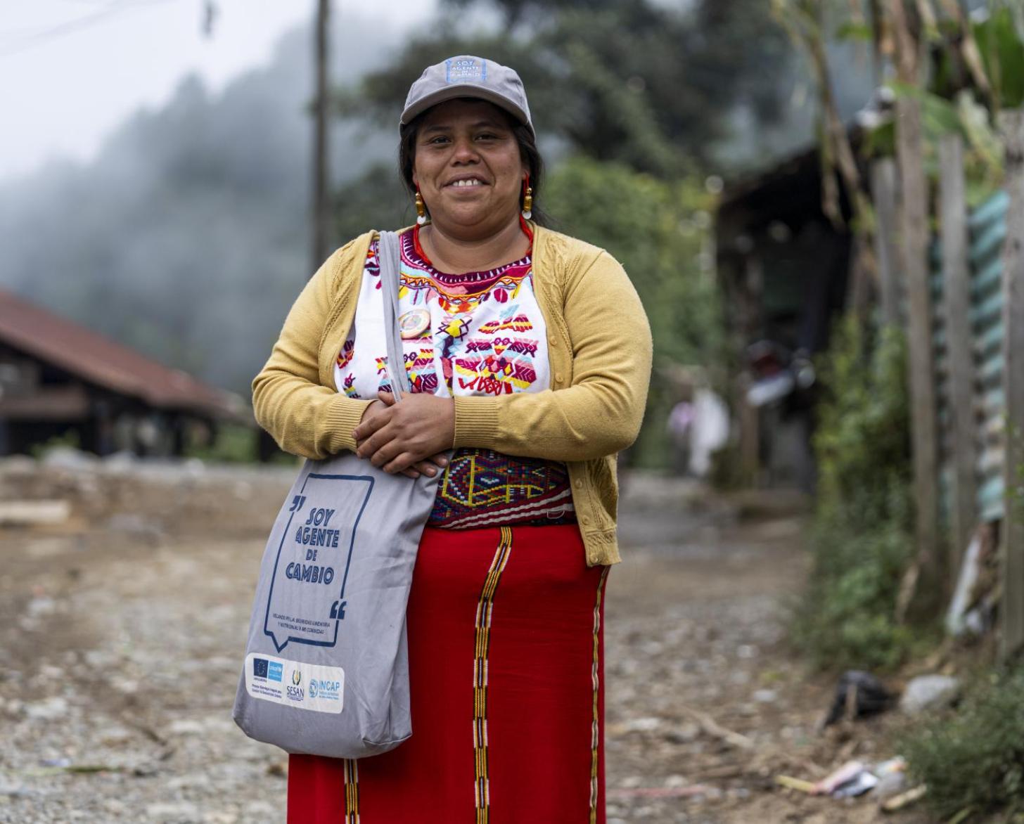 A woman looks at the camera and smiles