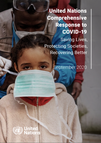Cover shows a UN staff member helping to place a protective face mask on a young girl