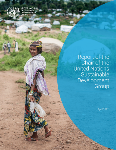A girl looking back as she walks across an open field.